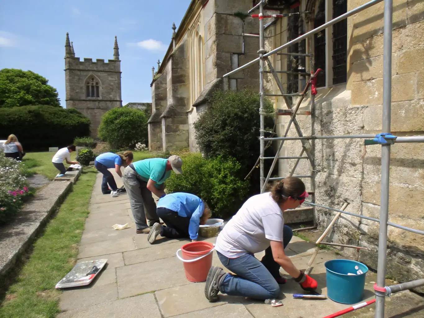 A vibrant image showcasing volunteers working on the restoration of a traditional stone building in the Millevaches region, emphasizing the organization's commitment to preserving local architecture.